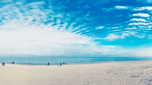 Scenic view of beach against blue sky