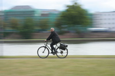 Man riding bicycle on road