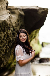 Portrait of a smiling young woman standing outdoors