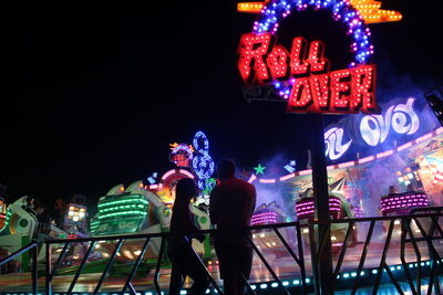 People at illuminated amusement park