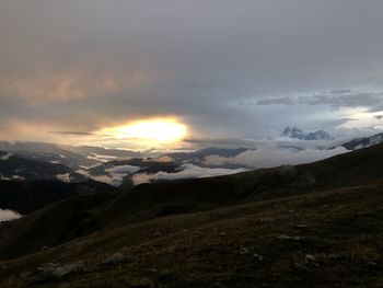 Scenic view of snowcapped mountains against sky during sunset