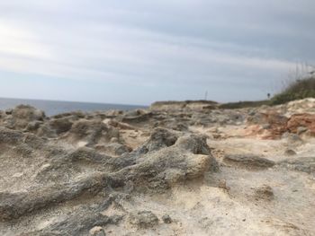 Rocks on beach against sky