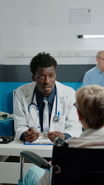 Portrait of female friends sitting at clinic