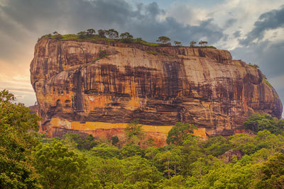 Rock formations on landscape against sky