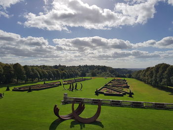 Scenic view of green landscape against sky