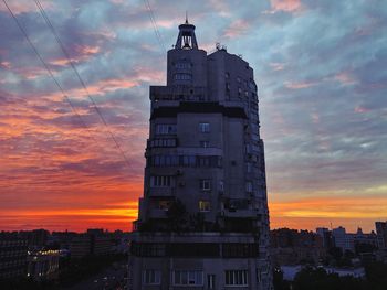 Low angle view of buildings against dramatic sky