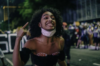 Portrait of smiling young woman in city