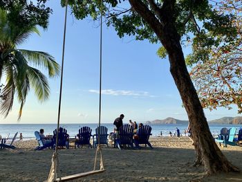 People at beach against sky