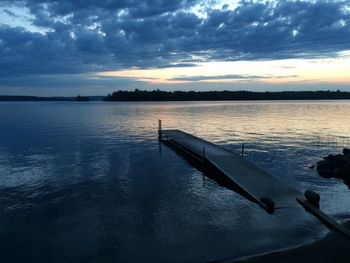 Scenic view of lake against cloudy sky