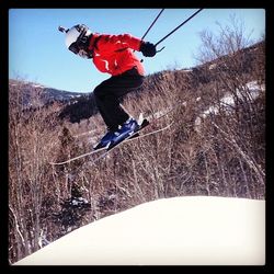 Young woman jumping on mountain