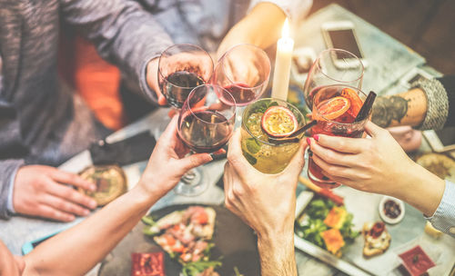 High angle view of people toasting drinks at restaurant