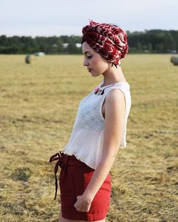 Side view of woman standing on field