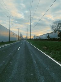 Empty road against sky during sunset