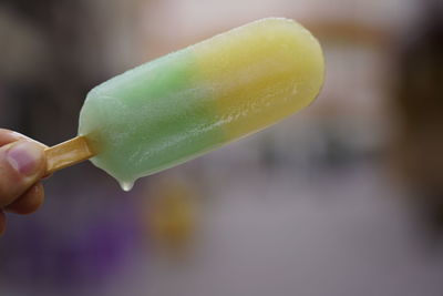 Close-up of hand holding ice cream cone