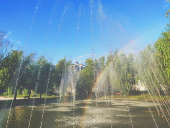 Fountain in park against sky