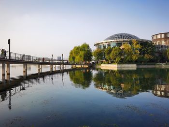View of bridge over lake against buildings