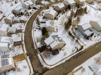 High angle view of snow covered houses on field