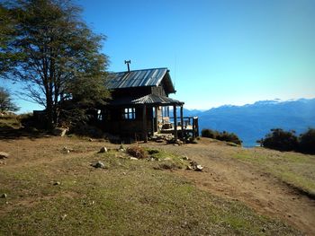 House on field against clear sky