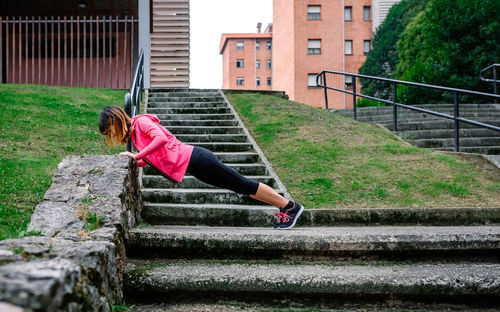 Rear view of woman on staircase