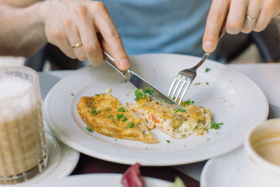 Midsection of man having food in plate