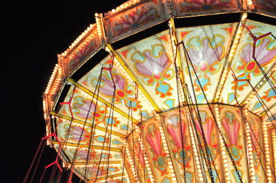 Low angle view of illuminated ferris wheel at night