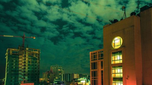 Low angle view of skyscraper against sky at night