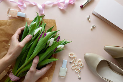 High angle view of hand holding vegetables on table