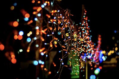 Defocused image of illuminated christmas lights at night