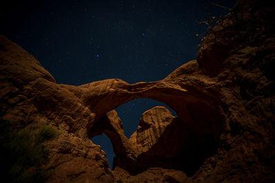 Low angle view of rock formation against sky at night