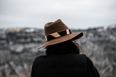 Rear view of woman standing against sky