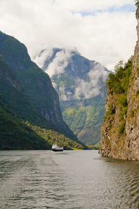 Scenic view of sea and mountains against sky