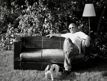 Portrait of woman sitting on chair at park