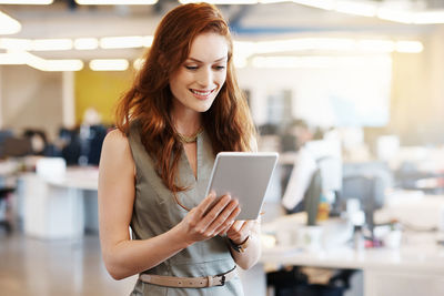 Young woman using mobile phone in laptop