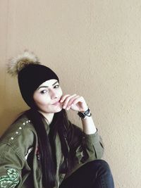 Portrait of young woman sitting outdoors