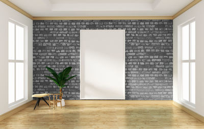 Potted plant on tiled floor against wall