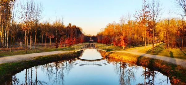 Reflection of trees in lake against sky during autumn