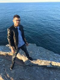 Young man sitting in sea