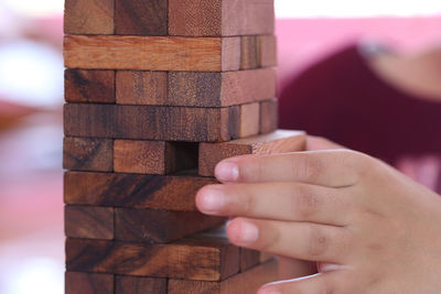 Cropped hand of person holding wood