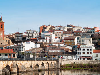 Buildings in city against clear sky