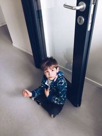 Child sitting by the door