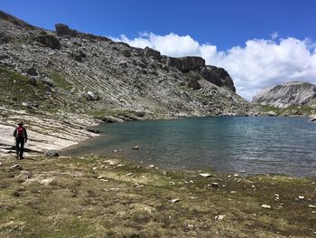  rocks by lake against sky in the dolomites, near passo gardena