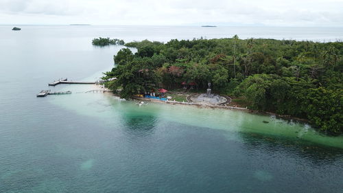 High angle view of trees by sea against sky