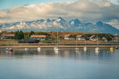 Scenic view of lake by mountains against sky