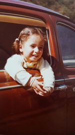 Portrait of cute girl sitting on seat