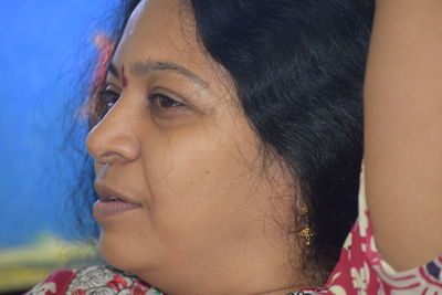 Close-up portrait of young woman looking away