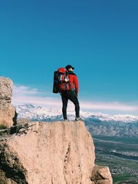 Rear view of man standing on rock