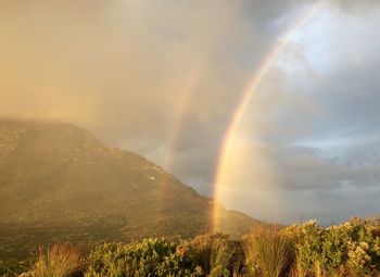 Rainbow over mountain against sky