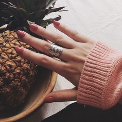 High angle view of woman hand touching pineapple