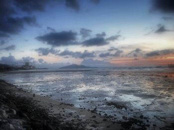 Scenic view of sea against cloudy sky