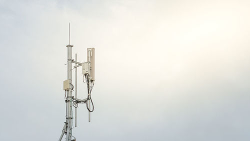 Low angle view of communications tower against sky